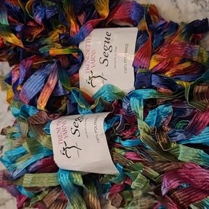 Trendsetter Yarns Segue 2 skeins. 1 rainbow, 1 turquoise and purples.